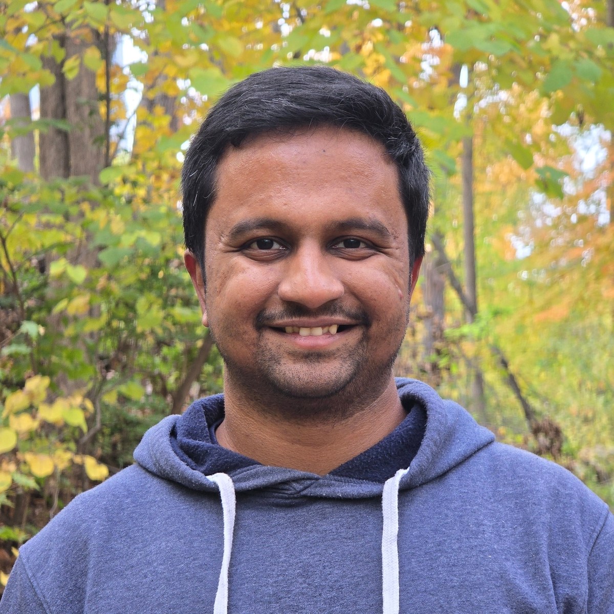 Vineeth Krishna Talasila outdoors among autumn trees